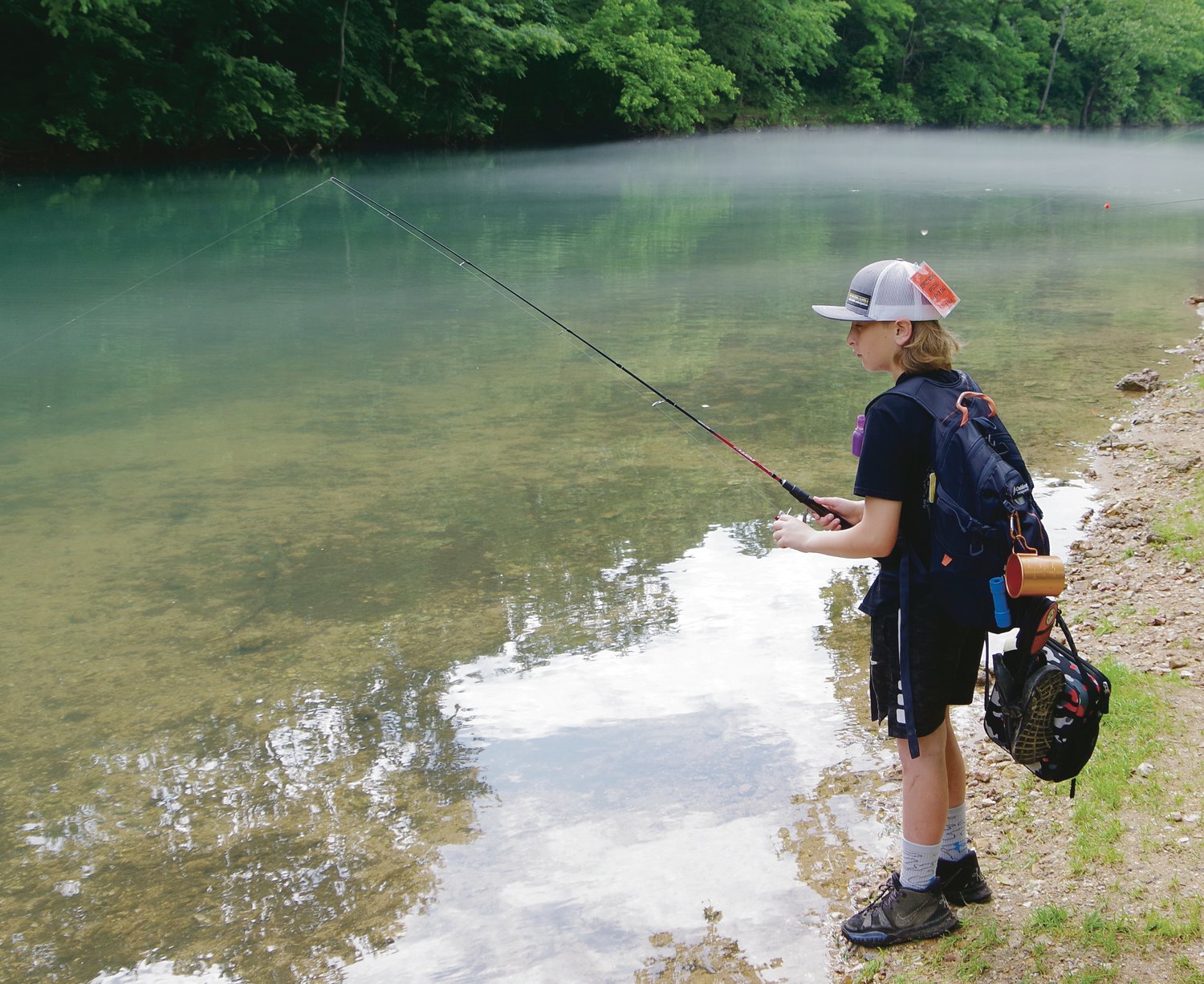 Aiden Hanson focuses on catching trout. Hanson, 11, said he did not have a favorite activity in the outdoor class. "I love it all," he said, but kayaking at Ha Ha Tonka and fishing in Bennett Spring State Park were very enjoyable.