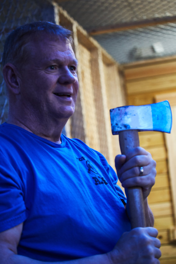 Jem Wheeler, co-owner of Top That Axe, shows the News + Record crew proper safety tips ahead of their axe-throwing experience in Pittsboro.