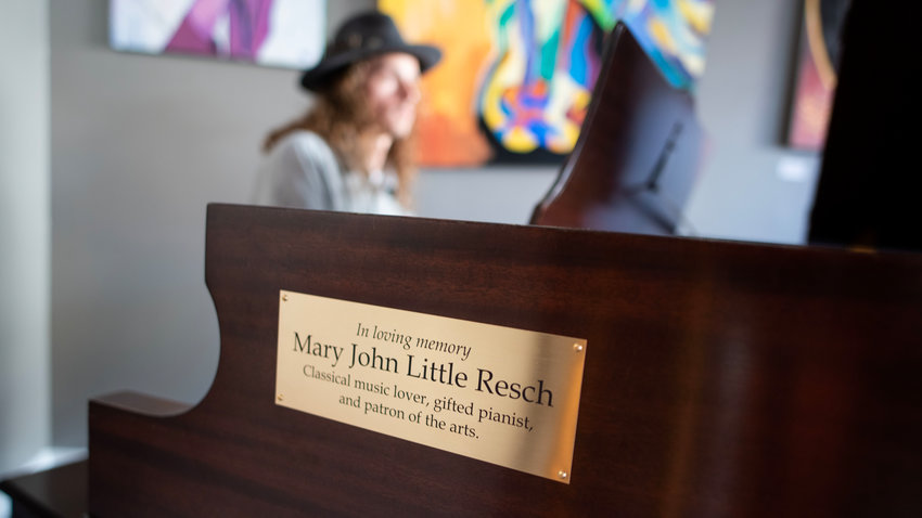 A plaque in memory of former Chatham News + Record owner Mary John Little Resch, who died in 2022, adorns a piano donated to the N.C. Arts Incubator in her memory. Dozens of people attended a celebration at the nonprofit art galley Saturday evening to celebrate Resch&rsquo;s life and the piano she used to own.