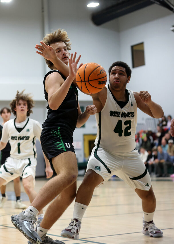 Zavante Thomas (42) of Woods Charter battles for the ball during the Wolves' opening game against FCA.