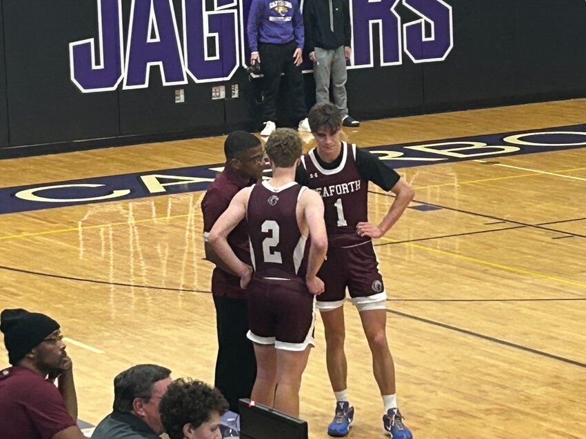 Seaforth&rsquo;s Declan Lindquist (1) and Campbell Meador (2) discuss strategy with coach John Berry during the Hawks&rsquo; loss to Carrboro.