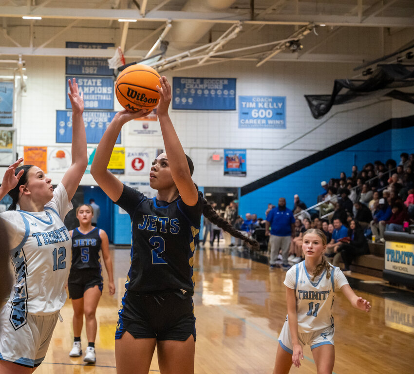Jordan-Matthews Jada Scott shoots the ball over Trinity&rsquo;s Ava Nance during a non conference match in the Tim Kelly Gym at Trinity High school in Trinity on November 18, 2024.