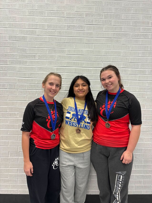 From left to right: Caleigh Warf (Chatham Central), Alexandria Zumano (Jordan-Matthews) and Payton Pickett (Chatham Central) pose with their medals at the Asheboro Cold Turkey Invitational.