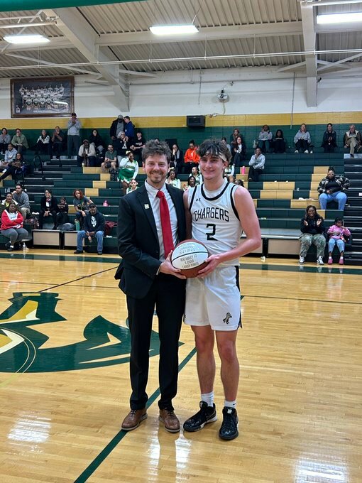 Northwood&rsquo;s Beau Harvey (2) poses with coach Matt Brown after the senior guard scored his 1,000th career point.