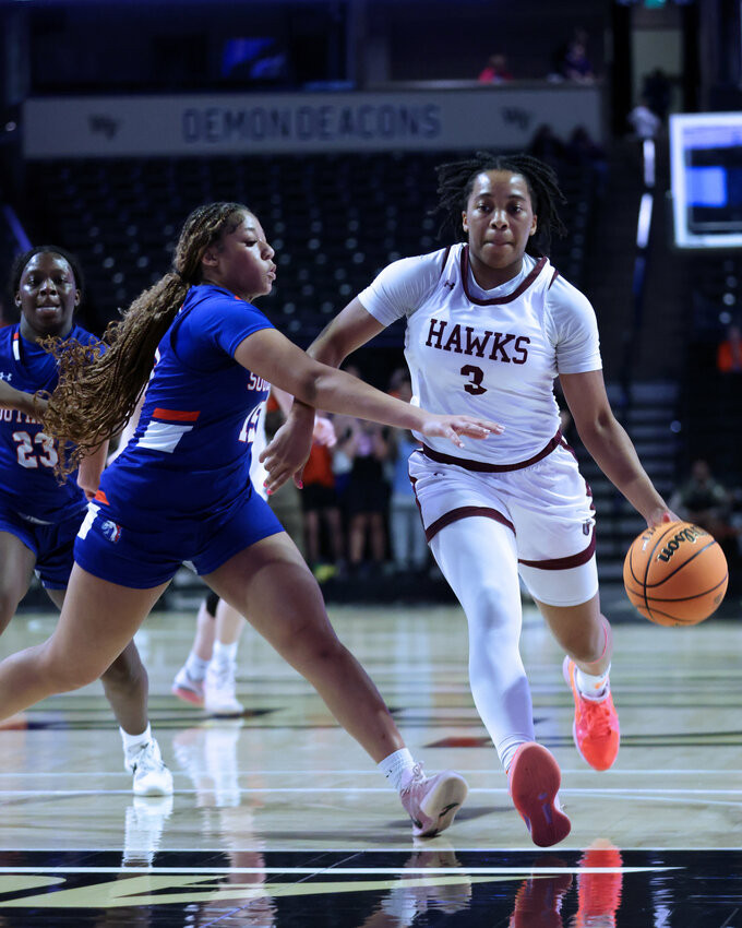 Gabby White (3) drives the lane during Seaforth&rsquo;s NCHSAA regional final against Southeast Alamance. White scored 10 for the Hawks, whose season ended with a three-point loss in the game