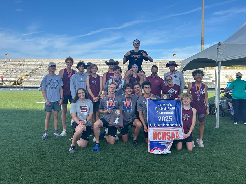 The Seaforth boys&rsquo; track and field team poses with the NCHSAA state championship banner