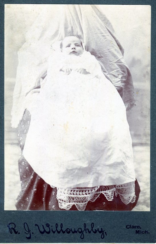 This &lsquo;hidden mother&rsquo; photo was taken in Clare by photographer Robert Willoughby. Willoughby operated a studio in Clare from 1898-1904. The child is not identified.    Photos like this are commonly called &lsquo;Hidden mothers&rsquo; as mothers stayed covered while holding their child still for long exposure times for early cameras.    Willoughby sold cabinet cards like this for 12 for $1.50.