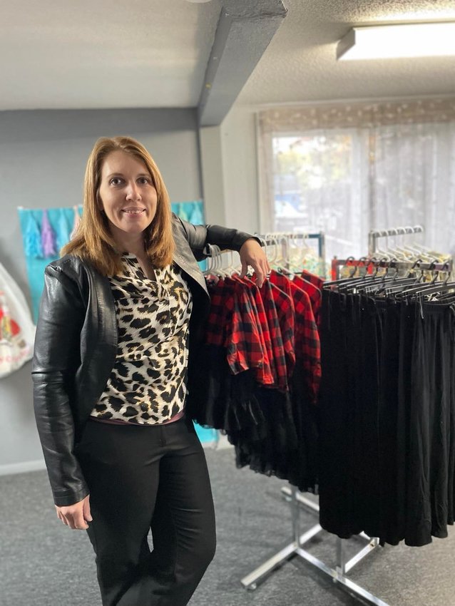 Jenna Neill poses in her new boutique space that offers clothes and accessories for children, teens and adults.