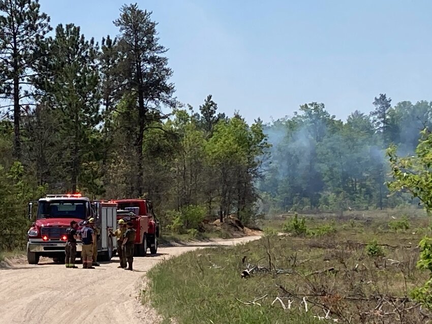 DNR firefighters work to suppress the Wilderness Trail Fire southeast of Grayling.