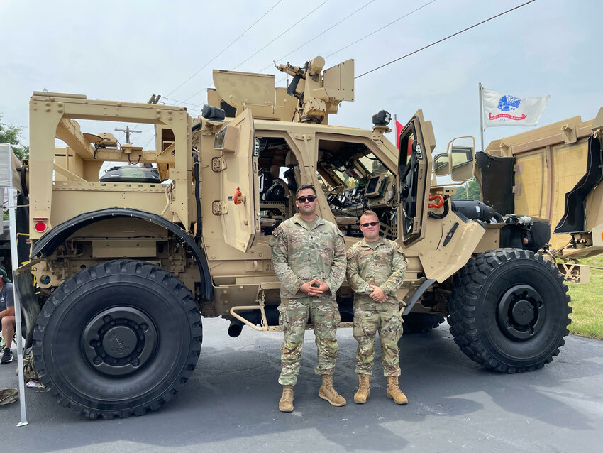 Guardsmen Max Robles and Edwin Burton of the Midland Army National Guard unit, stand in front of the Oshkosh M-ATV on display at the VFW Car, Truck and Bike Show. The military vehicle weighs 36,500 pounds and was driven to the event from the 46th Military Police unit in Corunna.