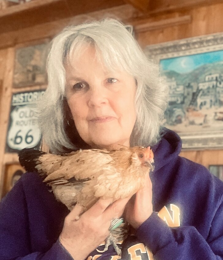 Marsi Darwin poses with Peanut, the world&rsquo;s oldest chicken. Darwin estimates Peanut&rsquo;s birthday is around May 1, making her 21 years old. Photo courtesy of Marsi Darwin