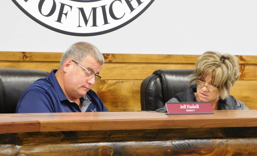 Under the guiding eye of Administrator Lori Phelps, BOC Chair Jeff Haskell applies his signature to the end-of-year documents solidifying the actions taken by the Clare County Board of Commissioners at its Sept. 29 special meeting.