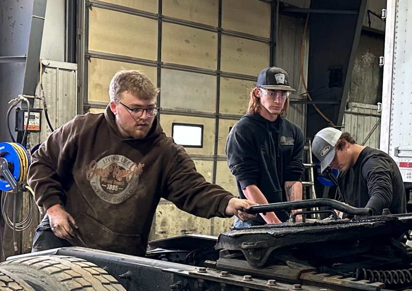 Diesel program students dive into hands-on learning about hitch maintenance.