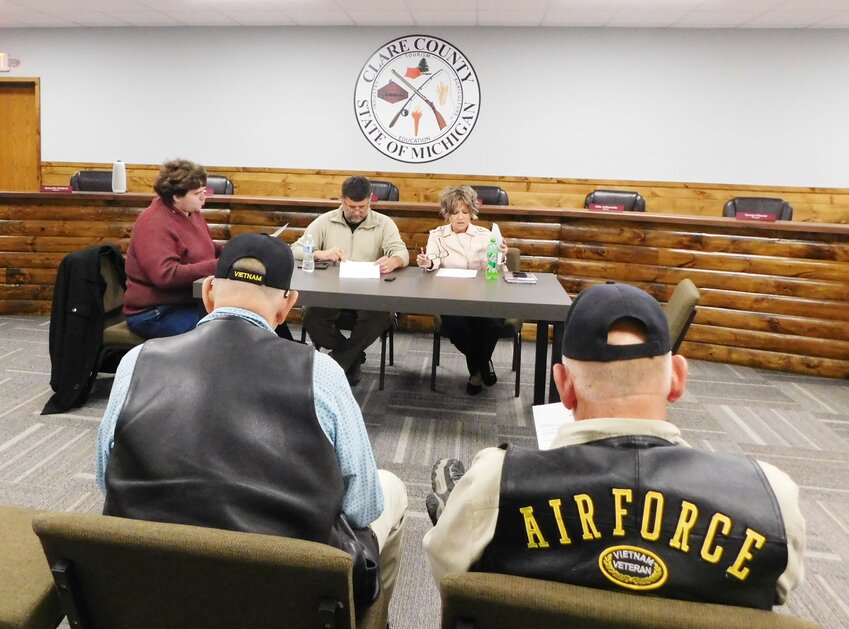 Taking up the business of the Clare County Airport at the October Airport Committee meeting are, from left, Commissioners David Hoefling and Gabe Ambrozaitis, and Lori Phelps, county administrator. Pictured in the foreground are pilot Carl Lounsbury and Gale Bensinger, airport manager.