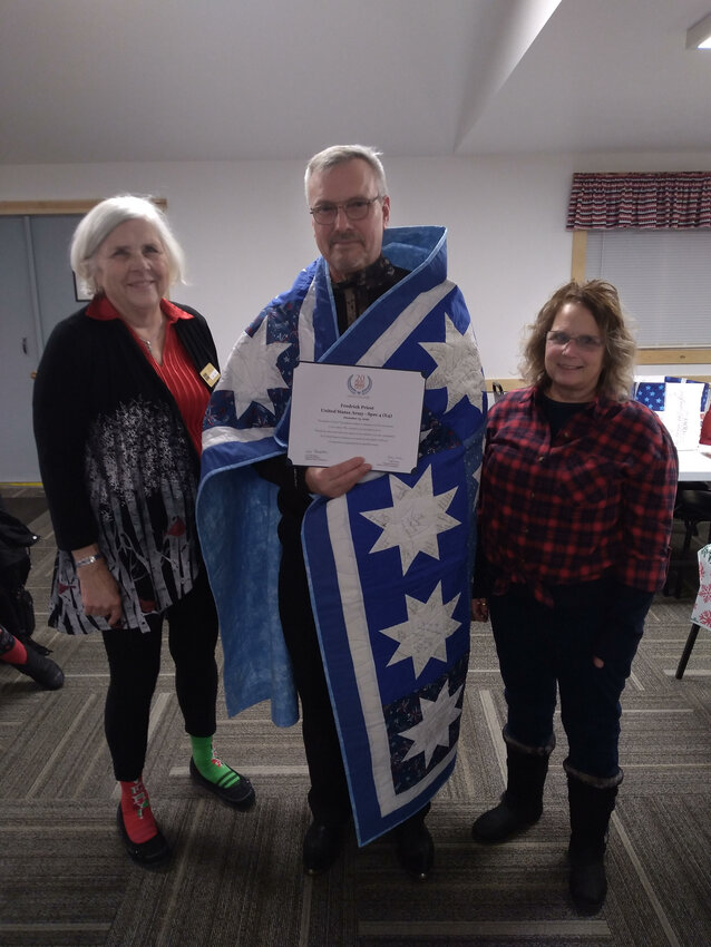 Quilt of Valor recipient Fredrick Priest, is shown with presenters Judy Tritten, left, and RaeAnn Loafman.