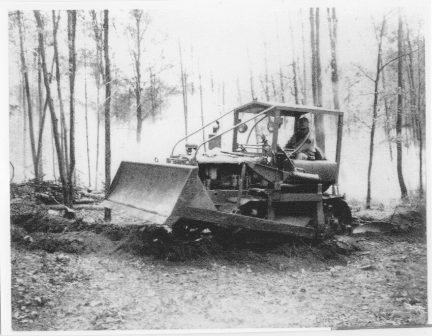 Photo by Roy Moran that appeared in the Clare County Cleaver of Vern Norman refreshing his plow line in the 1937 D-4 Caterpillar Tractor.