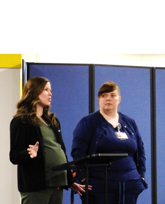 Michelle Wolf, P.A.-C, and Shelby Battle, CMA, inform the Harrison School Board members about the MidMichigan Health Community Health in-school health center, its services, effectiveness, and how it has been received and utilized by students/families.