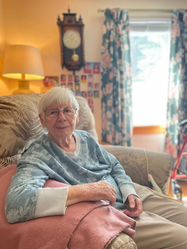 Paulette at home the day she was interviewed by the Clare County Cleaver in 2023. Her grandchildren and grandchildren grace her wall, and she proclaims them all very good looking.