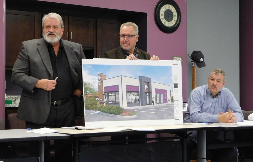 Greg Lautzenheiser of L&amp;A Architects in Rochester Hills, Mike Wizynajtys of REC Engineers in Ortonville, and Bob Grabowski, chief financial officer of Great Lakes Taco, LLC, Grand Blanc, are pictured with the rendering of the Taco Bell as it will be built at 714 N. First St. in Harrison.