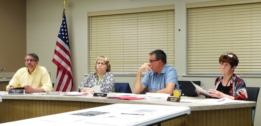 Hayes Township Board members, from left, Rick Jones, Deb Hoyt, Ernie Teall and Maye Tessner-Rood listen to the Hayes Planning Commission report made by chairperson John Marion.