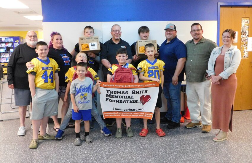 Receipt of the two AEDs represents a milestone in sports safety for local youth athletes. Participating in this big moment were Jonathan Smith of the Thomas Smith Memorial Foundation, as well as Harrison Youth Football board members, coaches and players.