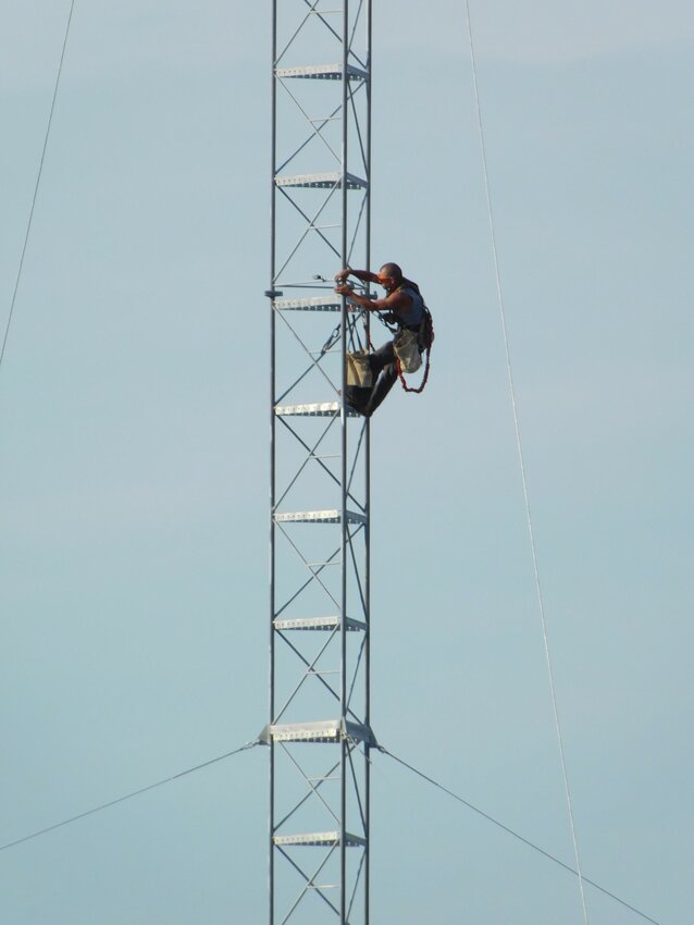 This tower technician, pictured June 3, has the township’s best view as he works to secure mounting brackets on the new communications tower located on the north side of Hamilton Township Hall property. Skyway Towers out of Florida has leased that portion of the property, and its contracted customer will be Verizon.