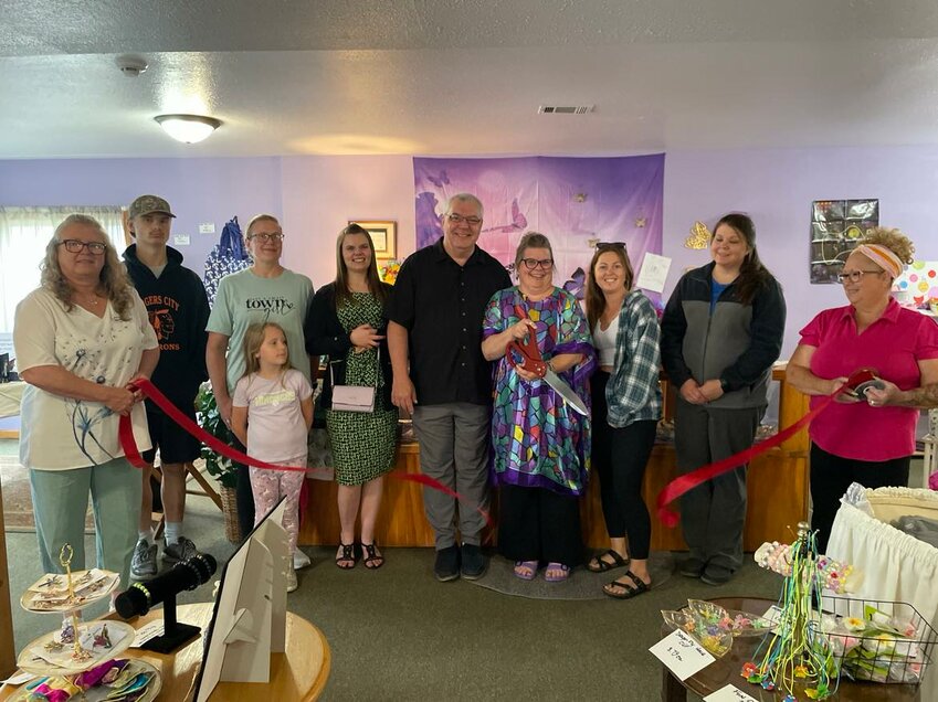 Members of the Harrison Area Chamber of Commerce and other local businesses join Kelly and Ray Denison to cut the ribbon on their new store on June 5.
