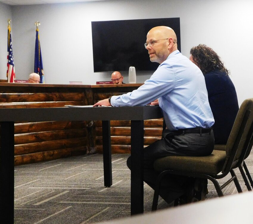 Bryan Krogman, left, and Sara Miceli-Sorensen provide commissioners with a Community Mental Health update.