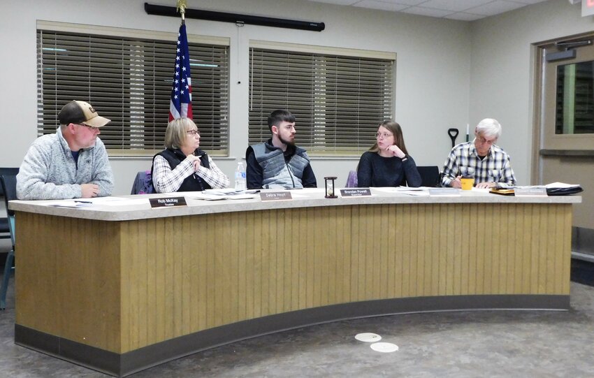 Hayes Township Board members listen as Treasurer Savannah Cavanaugh describes the low usage of the township’s TextMyGov program during the Board’s Feb. 25 meeting.