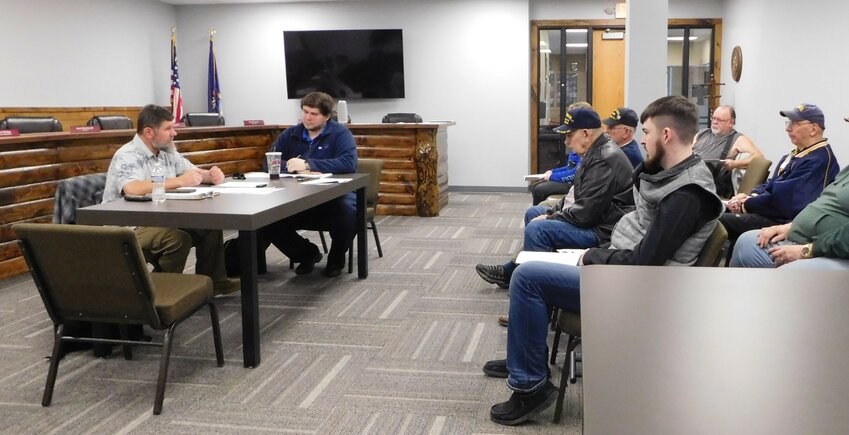 Gabe Ambrozaitis, Clare County Airport Committee chairman, (left) describes for fellow committee member David Hoefling and attendees the recent grant awards which will enable completion of the Airport 80D lighting upgrade project, as well as runway crack sealing.