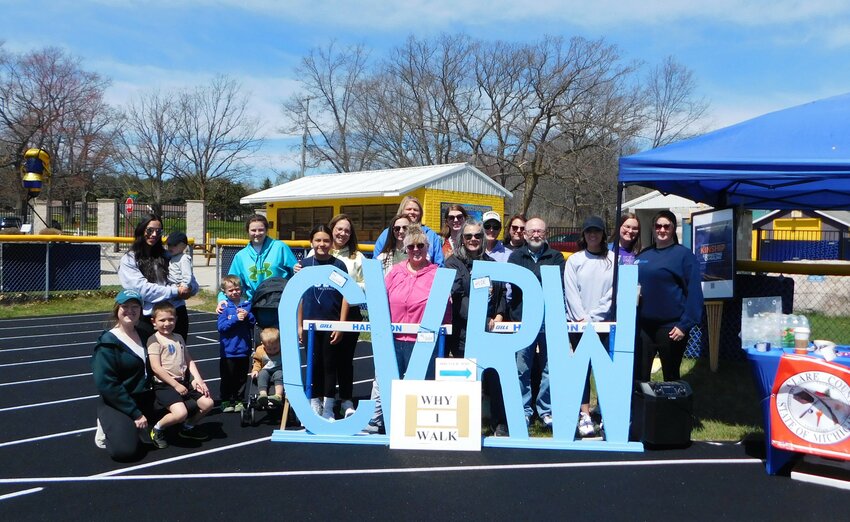 Representatives of the Clare County Prosecutor’s Office, Northern Michigan Alliance for Children, neighboring advocacy groups and local supporters gather for a group photo prior to the start of the Crime Victims’ Rights Awareness Walk. More walkers trickled in, as the event spanned a 3-hour time frame
