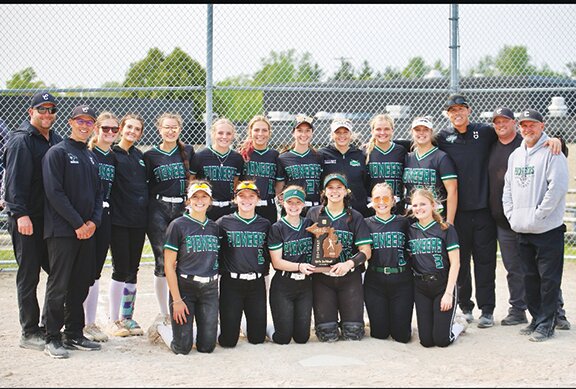 The Clare softball team poses with the district trophy after defeating Evart and Farwell on Saturday.