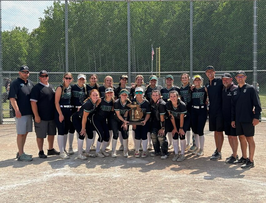 The Clare softball team poses with their Division 3 regional championship trophy on Saturday, after defeating Standish-Sterling and Bullock Creek.
