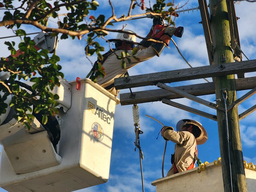 Utility crews work on East Carolina / Way 76 line across from TrueValue