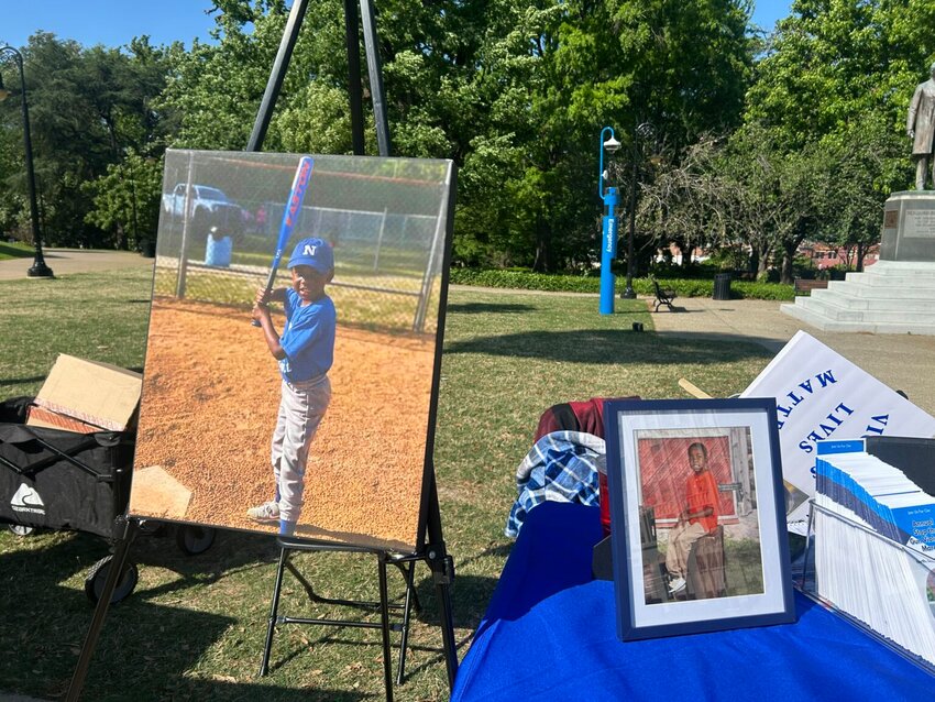 Photos of Winston Hunter, who was killed in 2022 at 6 years old during a drive-by shooting, sit outside the Statehouse at a Victims Matter Rally on Wednesday, April 9, 2025. (Photo by Skylar Laird/SC Daily Gazette)