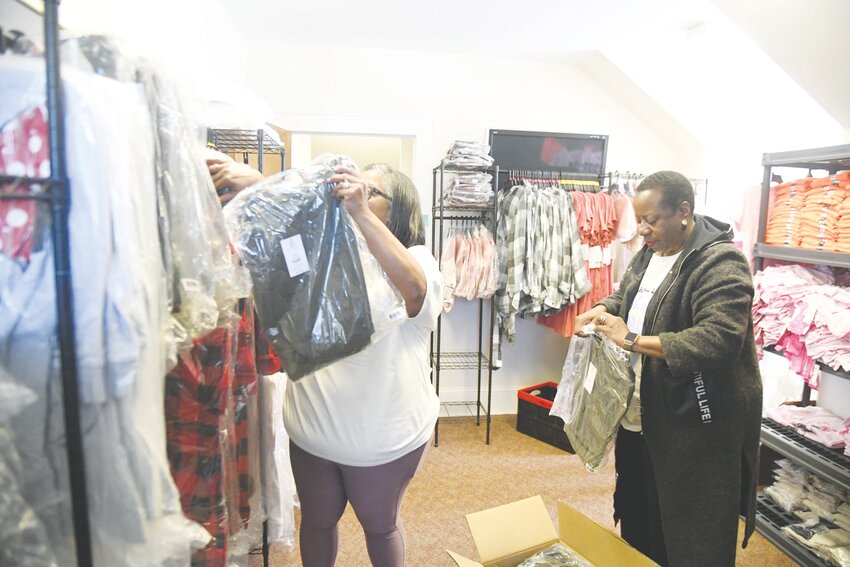 Angela Williams, President and CEO of United Way Worldwide, right, assists in the clothing closet of United Way of Laurens County.