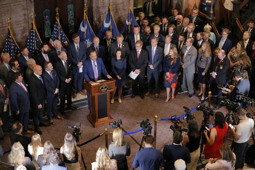 House Ways and Means Chairman Bruce Bannister, R-Greenville, (at the podium) outlines the GOP income tax plan on Tuesday, March 25, 2025, surrounded by House and Senate Republicans. (Photo by Travis Bell/STATEHOUSE CAROLINA/Special to the SC Daily Gazette)
