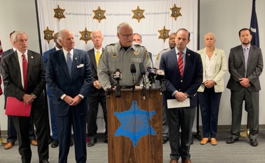 Local, state and federal law enforcement gather Monday, June 2, 2025, to announce arrests during a raid of a Summerville-area nightclub a day earlier. (Left to right, front row): State Law Enforcement Division Chief Mark Keel, Gov. Henry McMaster, Charleston County Sheriff Carl Ritchie and Attorney General Alan Wilson. (Screenshot of Charleston County Sheriff’s Office livestream)