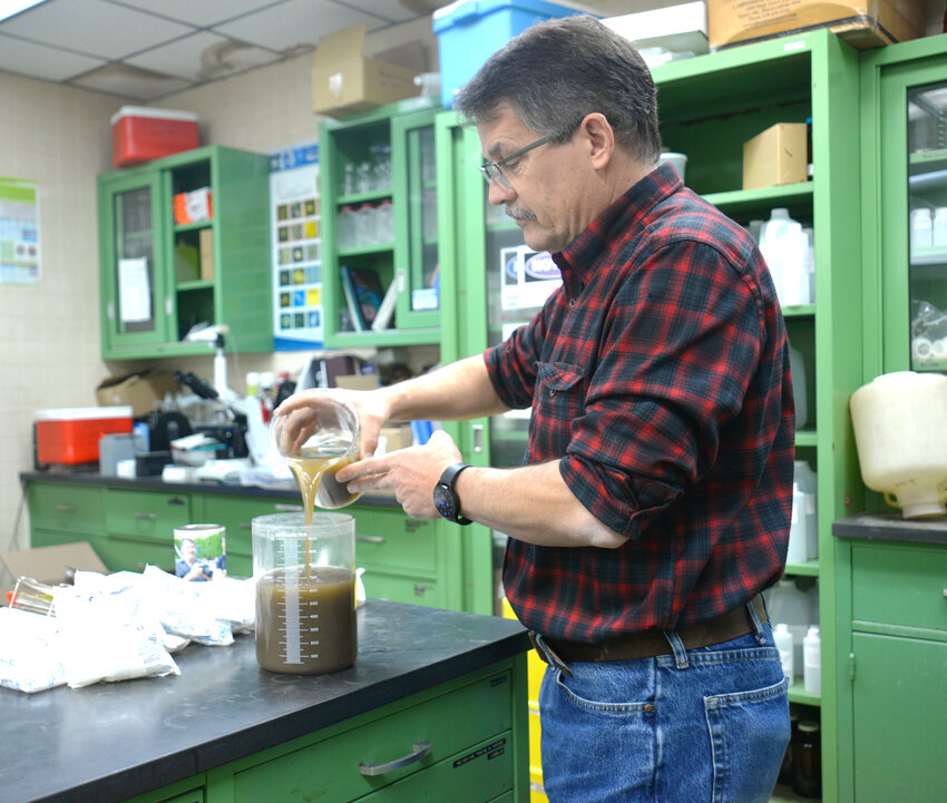 Bruce Adams, Cortland's  wastewater treatment supervisor, examines a sample of activated sludge in November. The city has received a $2.2 million grant to improve efficiency at the plant, and reduce phosphorus and nitrogen emissions into the Tioughnioga River and the Chesapeake Bay watershed.