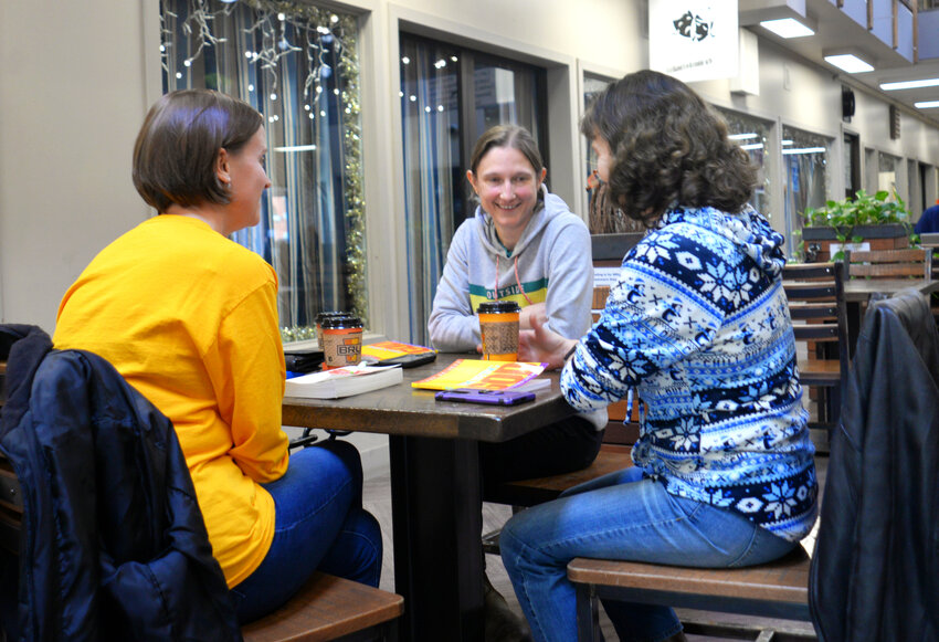 Summerhill resident Merideth Schlader, back, with  Cathy Smith of Cortland, right, and Shannon Eggleston of McGraw, said through the pandemic, they learned how important to make an effort at keeping social connections. These three were doing just that, discussing a faith-based book together at the Marketplace Mall on Main Street in Cortland.