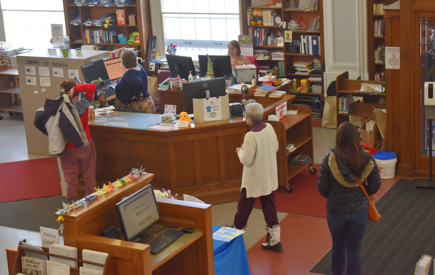 Cortland Free library staff members, homeless patrons and others mingle Monday. Across the library about mid-day, many people slept. Later in the day, noise grew.