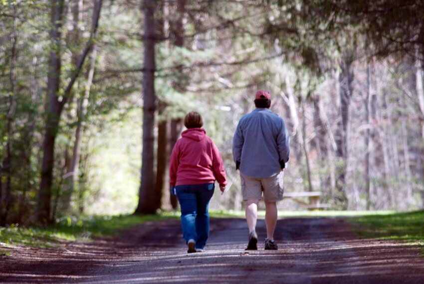 Two people walk through the woods in 2021 at Dwyer Memorial Park in Little York. The Cortland County Legislature approved a measure Thursday to install sidewalks on Little York Lake Road leading to the park to improve safety, but stopped short of installing sidewalks in the park itself.