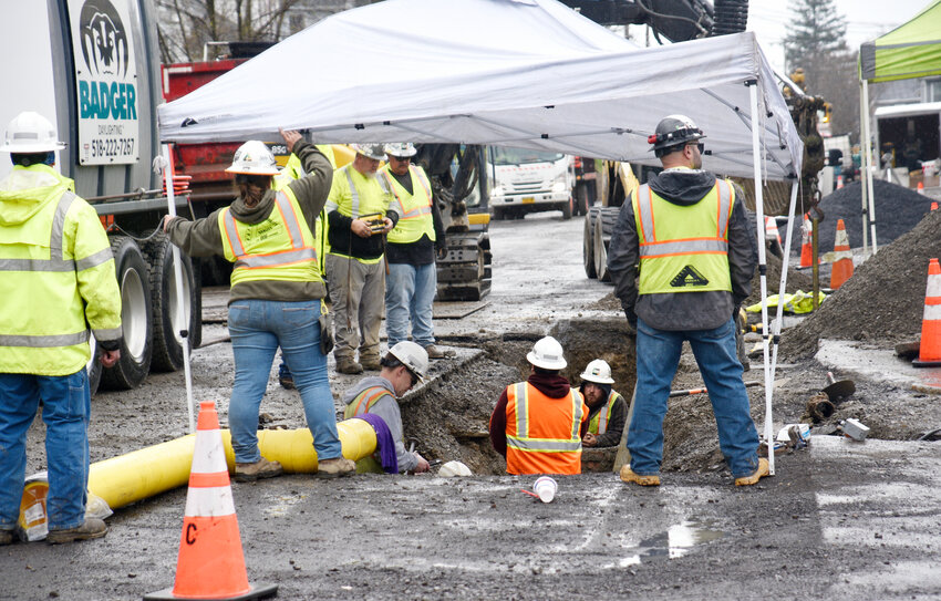 Contractors working under a tarp on a rainy Wednesday afternoon replace utility lines under Groton Avenue just west of Homer Avenue in Cortland. It is part of a project to rebuild the street and replace sidewalks and street lights that will continue through the summer.