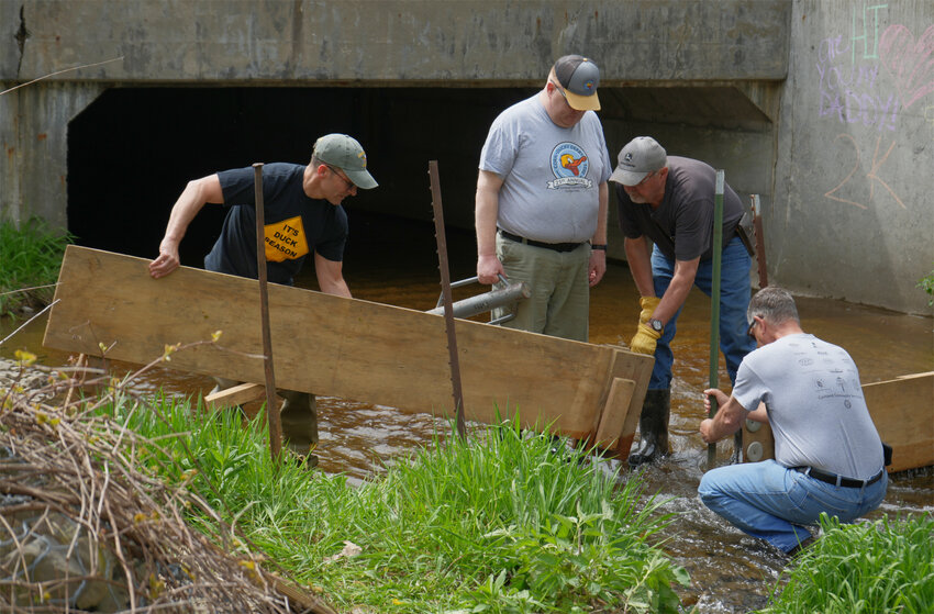Volunteers from the Cortland Community Service Club build the dam Friday for today's Corn Ducky Derby, a fundraising event for youth programs in Cortland County. Last year, the club had a record-breaking number of ducks -- 8,900.