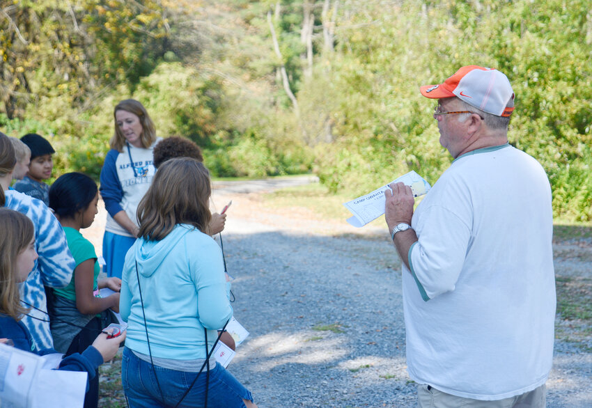 Shawn Forney, president of the Central New York Orienteering Club, teaches Homer sixth graders about orienteering Friday during the annual Conservation Field Days. A total of 300 to 350 students from greater Cortland area schools attended the event at Camp Owahta in Solon.