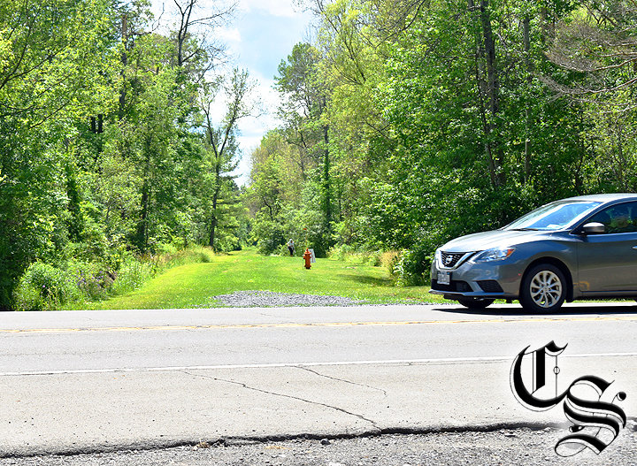 A car traveling on Route 13 near Etna passes by the Dryden Rail Trail in 2022. The location is where the town plans a pedestrian bridge to let hikers cross the highway.