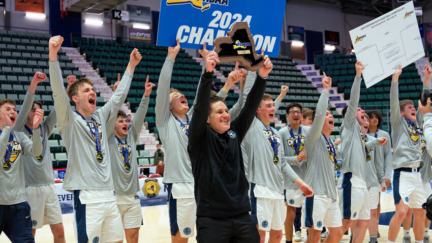 The Moravia boys basketball team celebrates after winning the Class C state championship over Haldane Saturday at Cool Insuring Arena in Glens Falls.