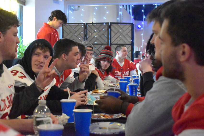 SUNY Cortland football players eat at the Community Celebration for them held at the Center for the Arts of Homer Thursday night. The team won the NCAA Division III national championship in December.