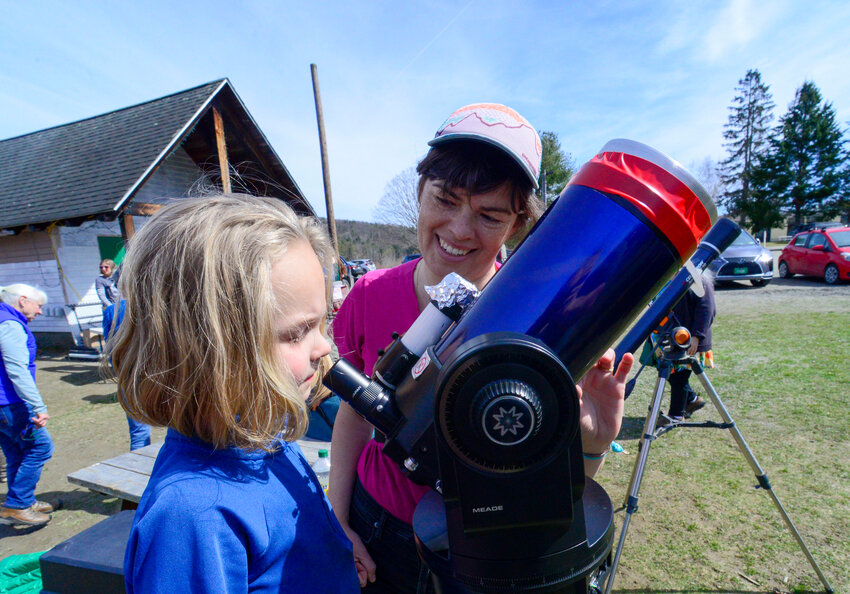 Alder Finlay-Morrison, 7, of Brattleboro, Vt., looks through a special telescope that was set up by Emily Zervas, the director of the Putney, Vt., Library, during an event at the Putney Central School as part of the solar eclipse on Monday, April 8.