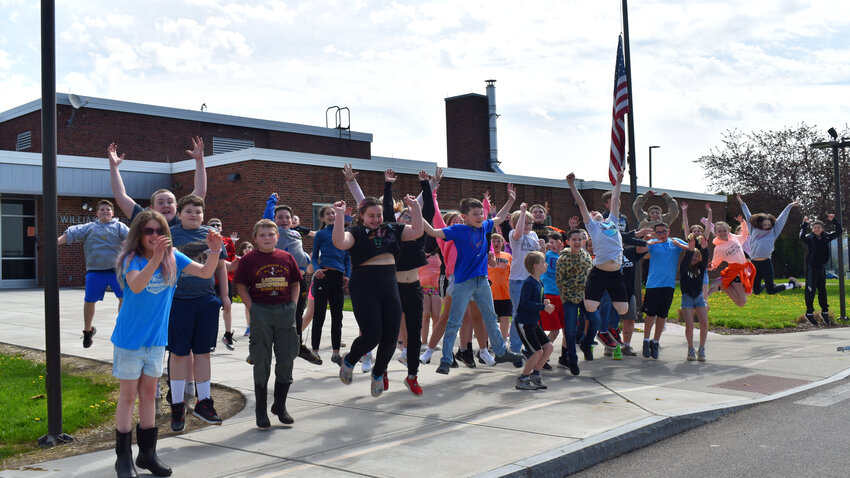 The fifth-grade Marathon class jumps for joy in front of Olympian Lane, the half-circle on front of Appleby Elementary. The class successfully petitioned to name the street after learning about Marathon's history, and realizing the bus circle was nameless.